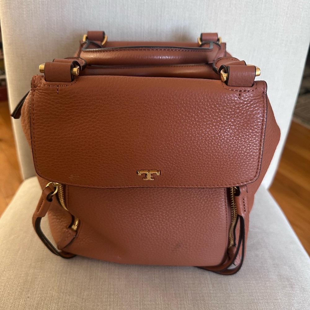 a Tory Burch Half Moon satchel in brown leather.